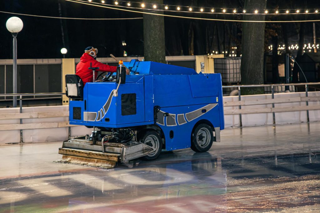 a-stadium-worker-cleans-an-ice-rink-on-a-blue-mode-2022-01-11-04-16-17-utc