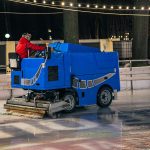 a-stadium-worker-cleans-an-ice-rink-on-a-blue-mode-2022-01-11-04-16-17-utc